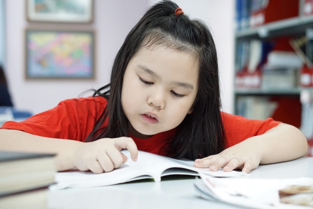 Young student reading at school