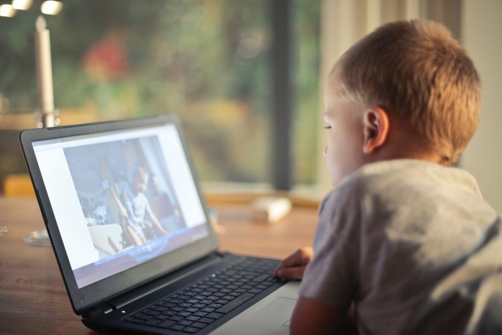 Boy watching video on laptop
