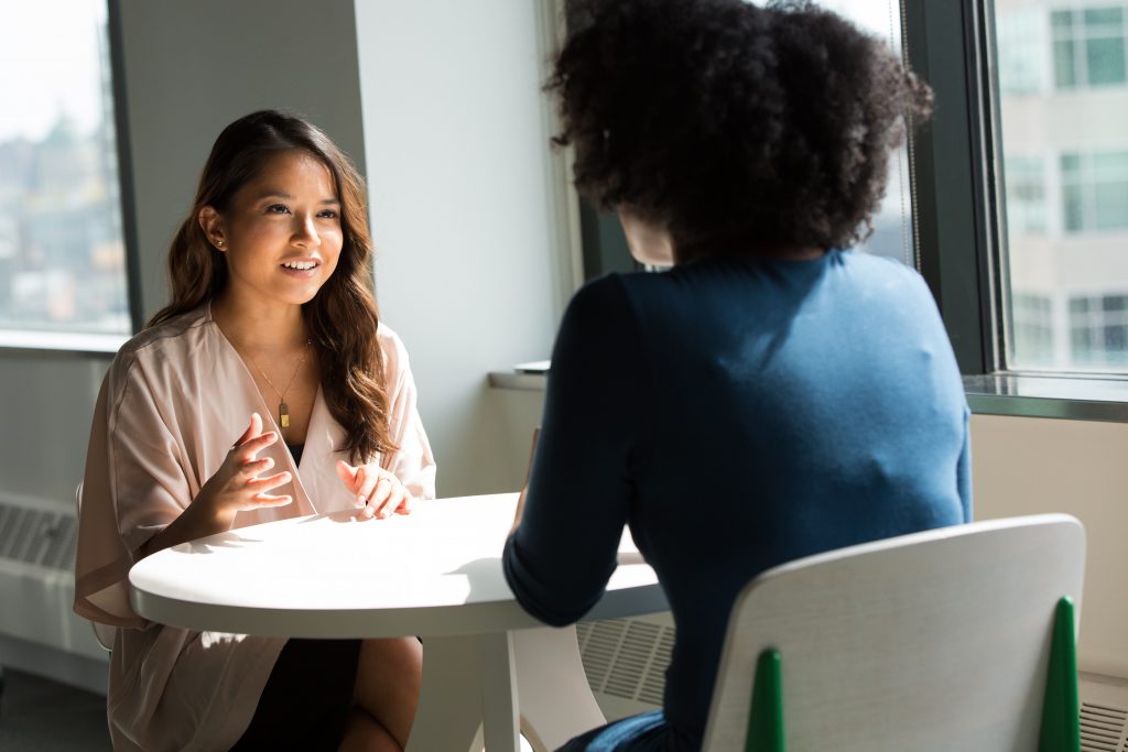 Two women talking across a table