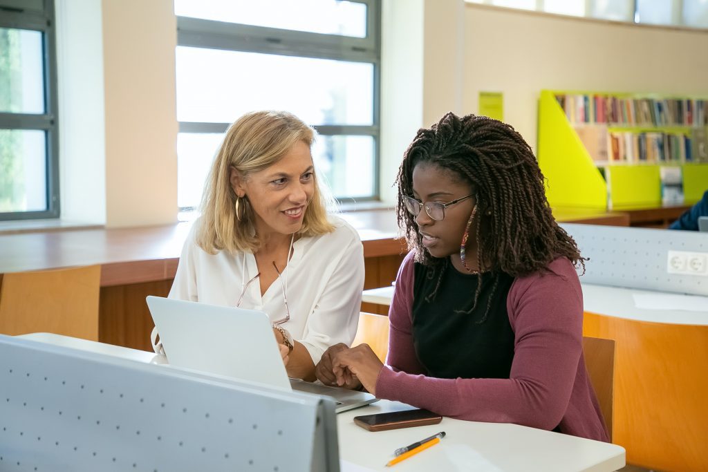 Two women working together in the school library