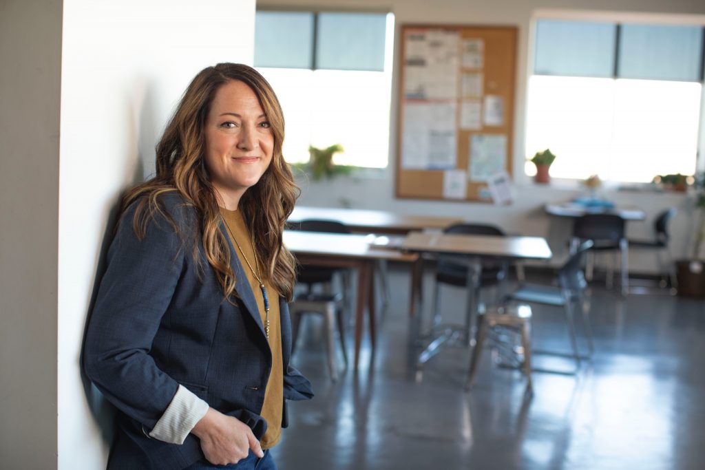 Woman standing in doorway of classroom