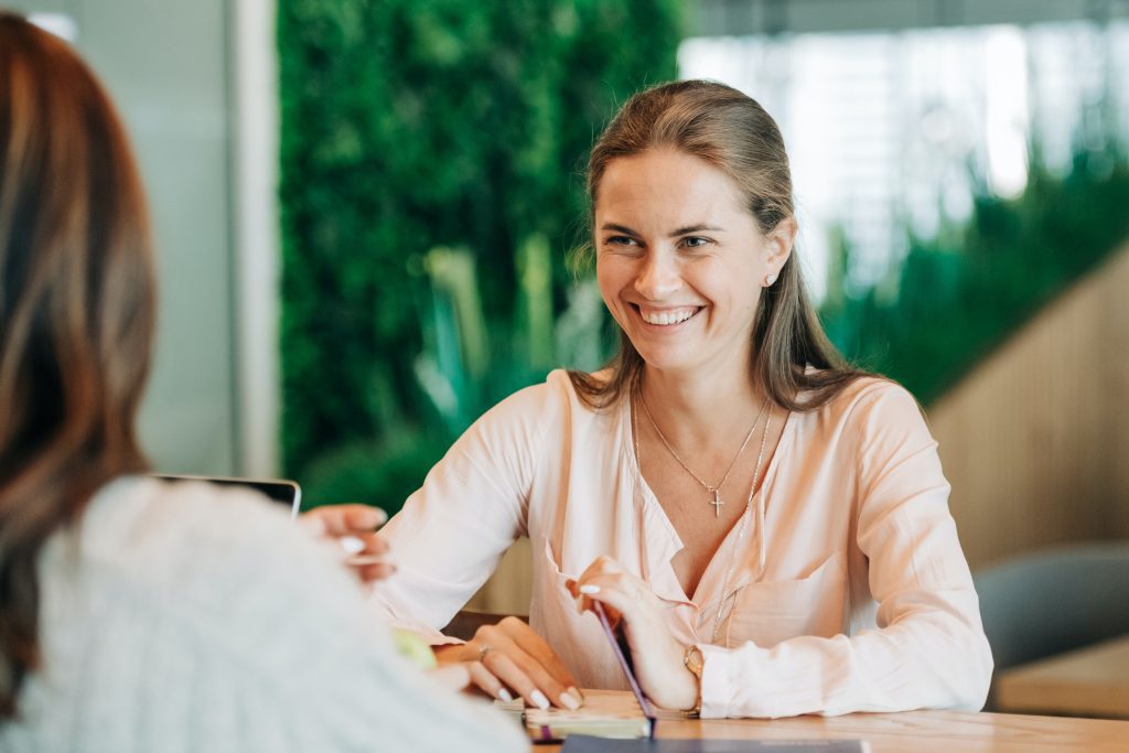 Two women having a conversation across a table