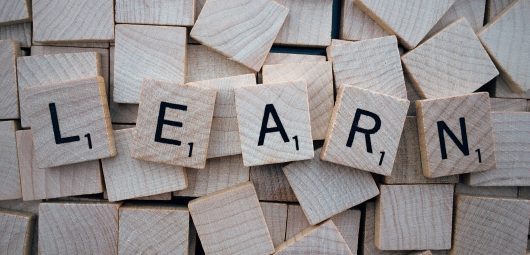 The word "LEARN" in scrabble tiles